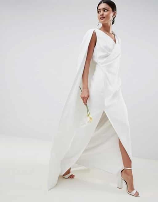 Woman in white caped dress walking