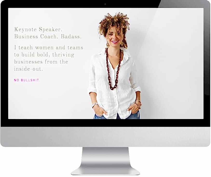 Cyndie Spiegel's Squarespace Website with an image of Cyndie in a casual white button down shirt and a large necklace on a mac-style computer monitor. The text reads: "Keynote Speaker. Business Coach. Badass. I teach women and teams to build bold, thriving businesses from the inside-out. No bullshit."
