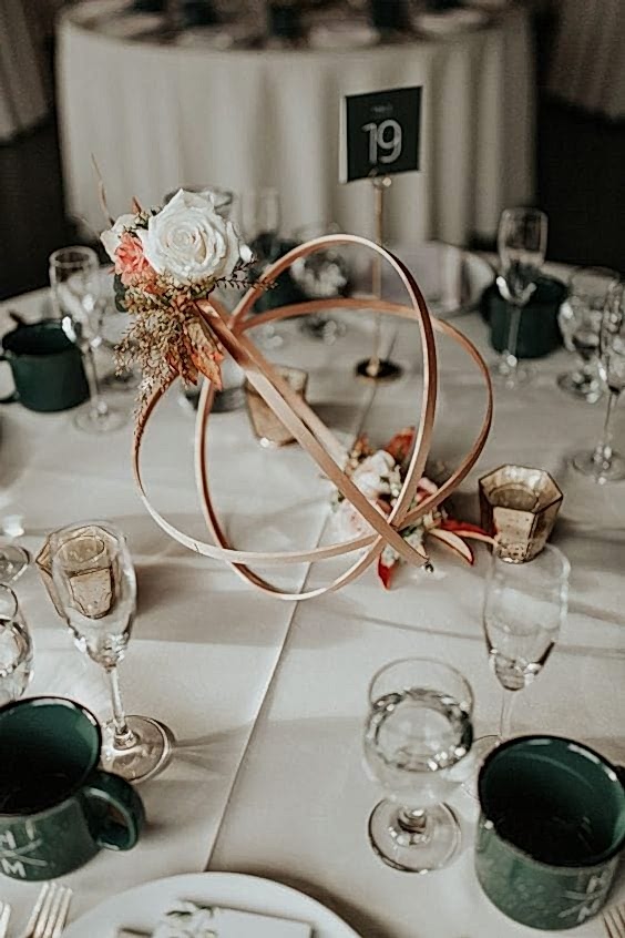 wedding ideas for abstract centerpieces with flowers—a bronze metal orb with coordinating flowers
