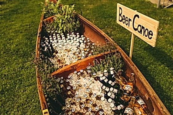 wedding ideas for beer in a canoe with a yard sign that reads "Beer Canoe"