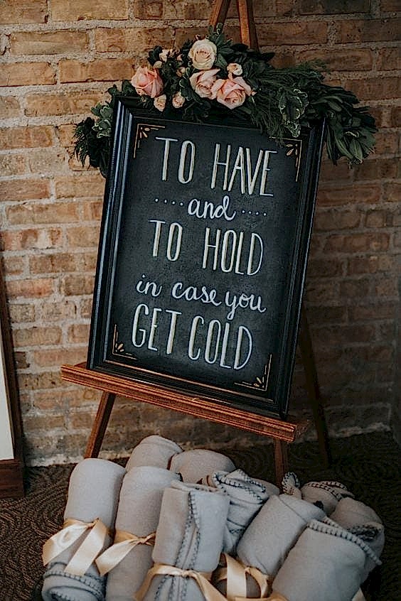 wedding ideas for a blanket basket at wedding reception with a chalkboard sign that reads "To have and to hold in case you get cold"
