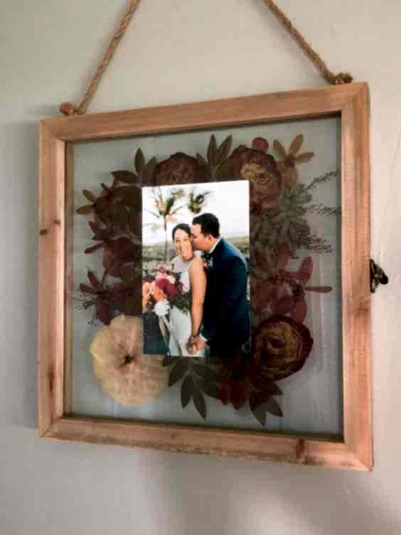 wedding ideas for bouquet preservation—pressed flowers in a frame with a wedding picture