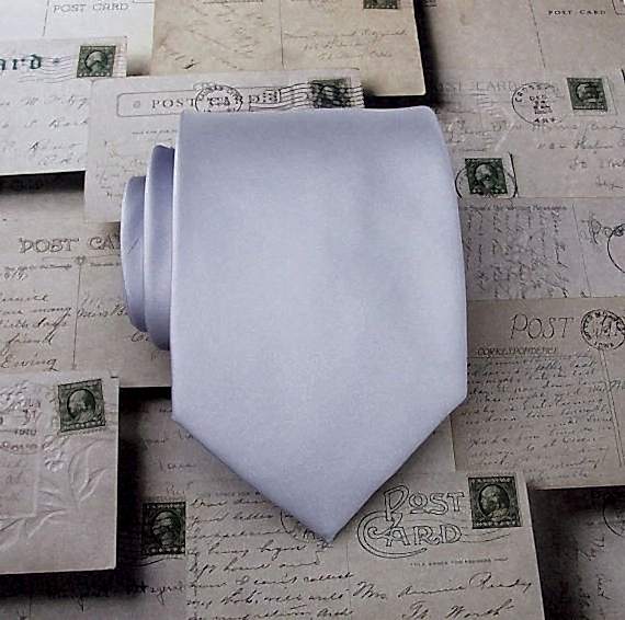 rolled up tie on vintage postcards in winter wedding colors: lavender