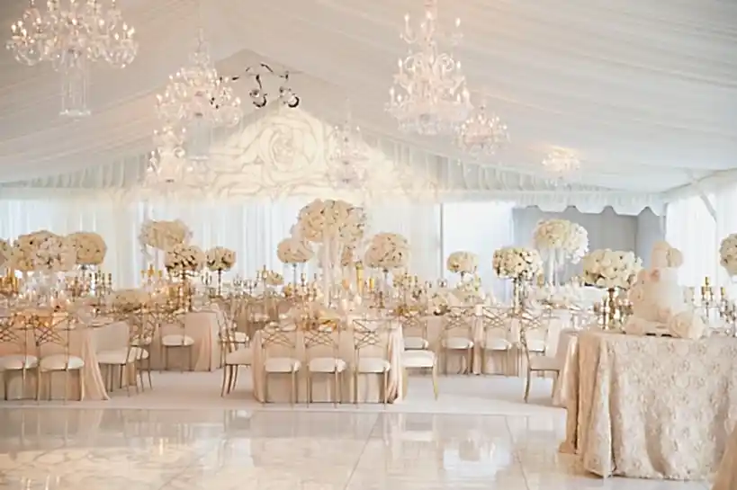 elegant banquet room decorated in white and gold winter wedding colors