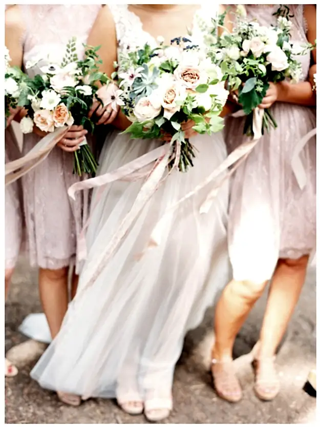 Bride and bridesmaids in cool pink and light blush winter wedding colors