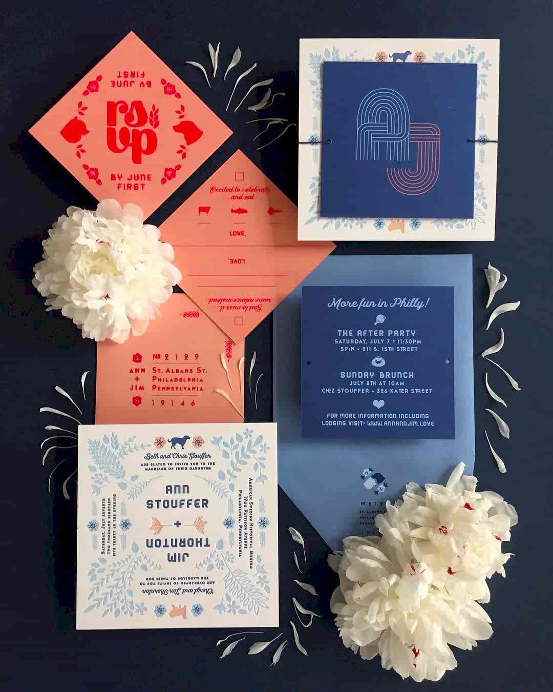 flat lay of coral and navy-colored wedding invitation suite with affordable letterpress printing by Thomas Printers