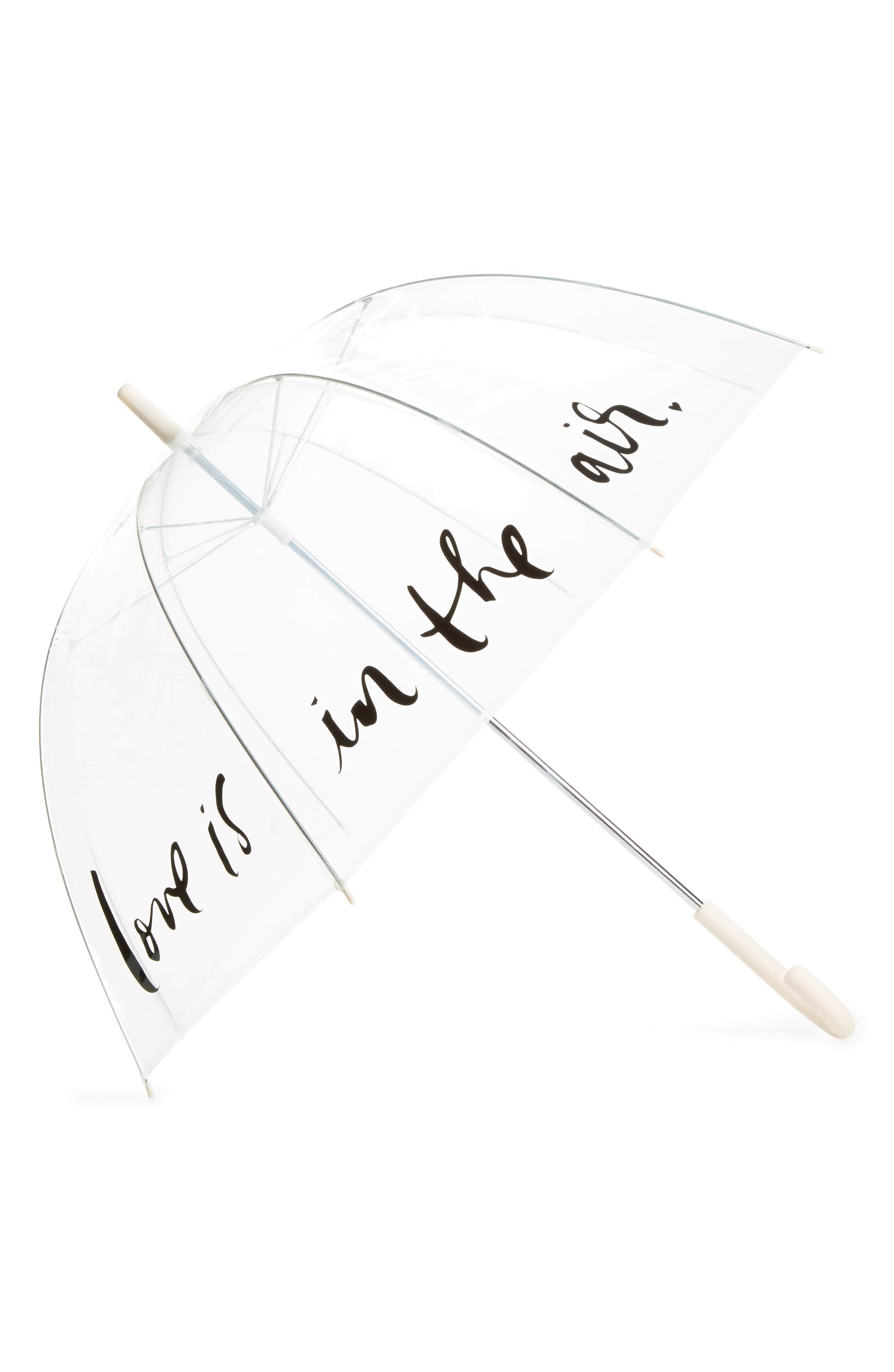 product shot of a clear wedding umbrella for rain with the words 'love is in the air' printed on it