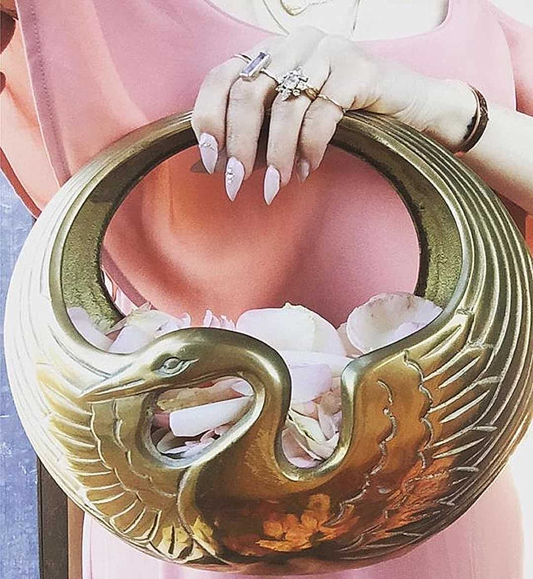 a brass swan flower petal holder that could be used in a wedding without flowers