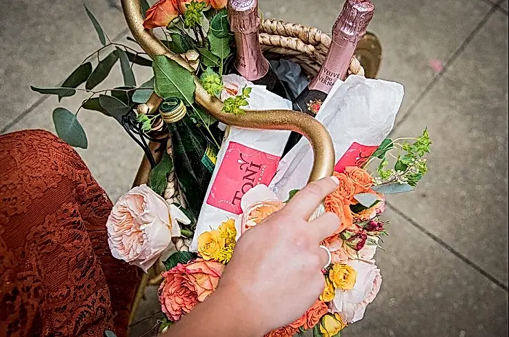 engagement party ideas a picnic party—a close up of bike handlebars and bike basket with picnic items