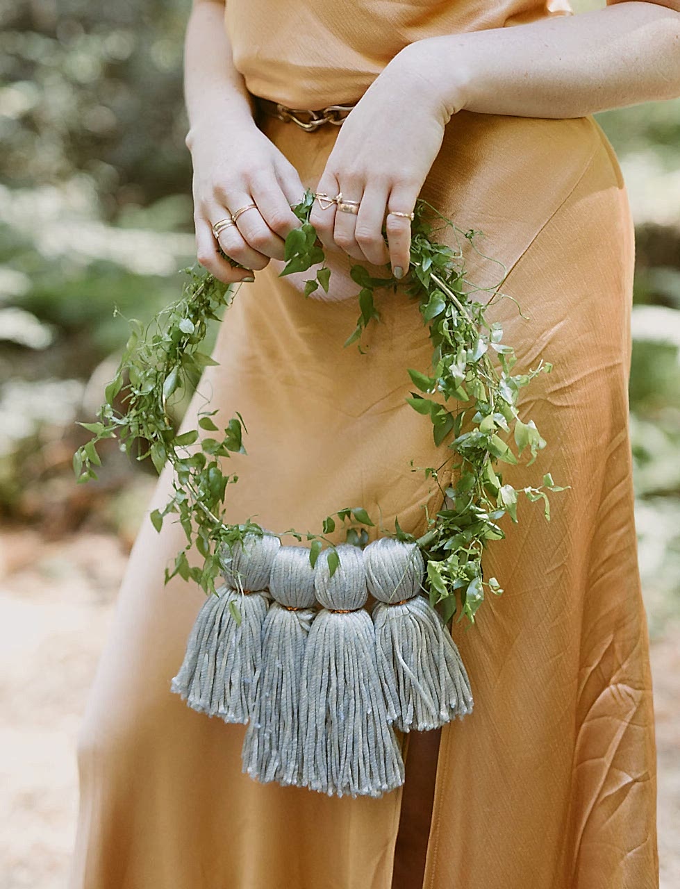 a woman carries a fringe hoop at her wedding without flowers