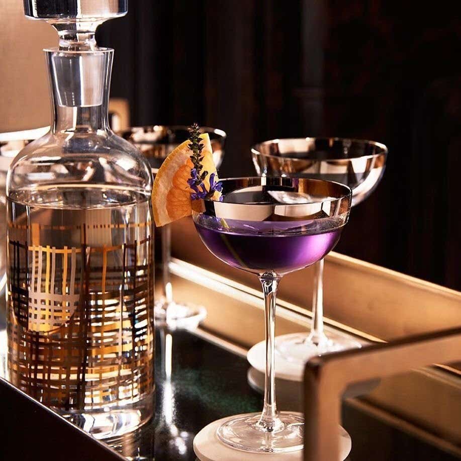 engagement party ideas for two elegant cocktails on bar cart with decanter with gold accents