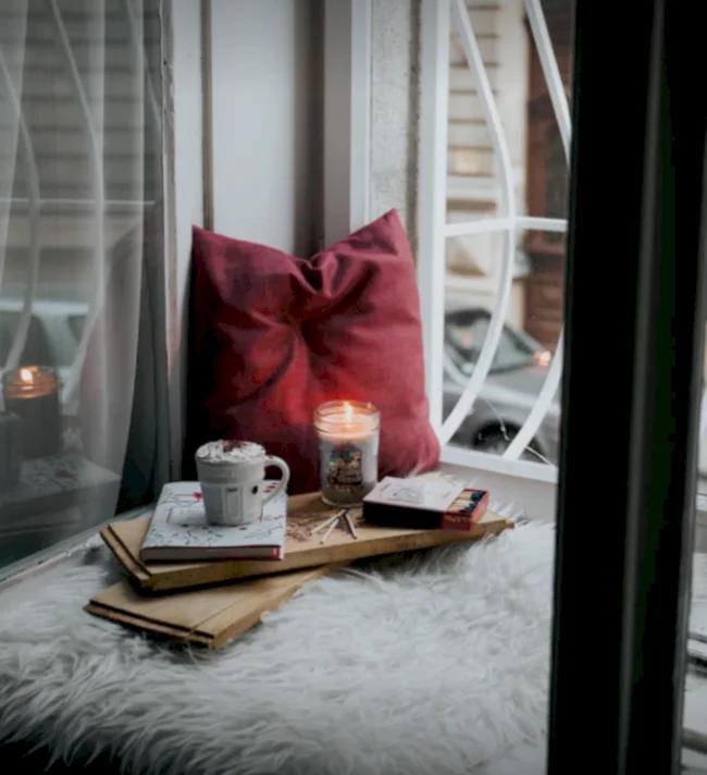 Cozy corner featuring high pile rugs, pillows and cocoa as an engagement party idea