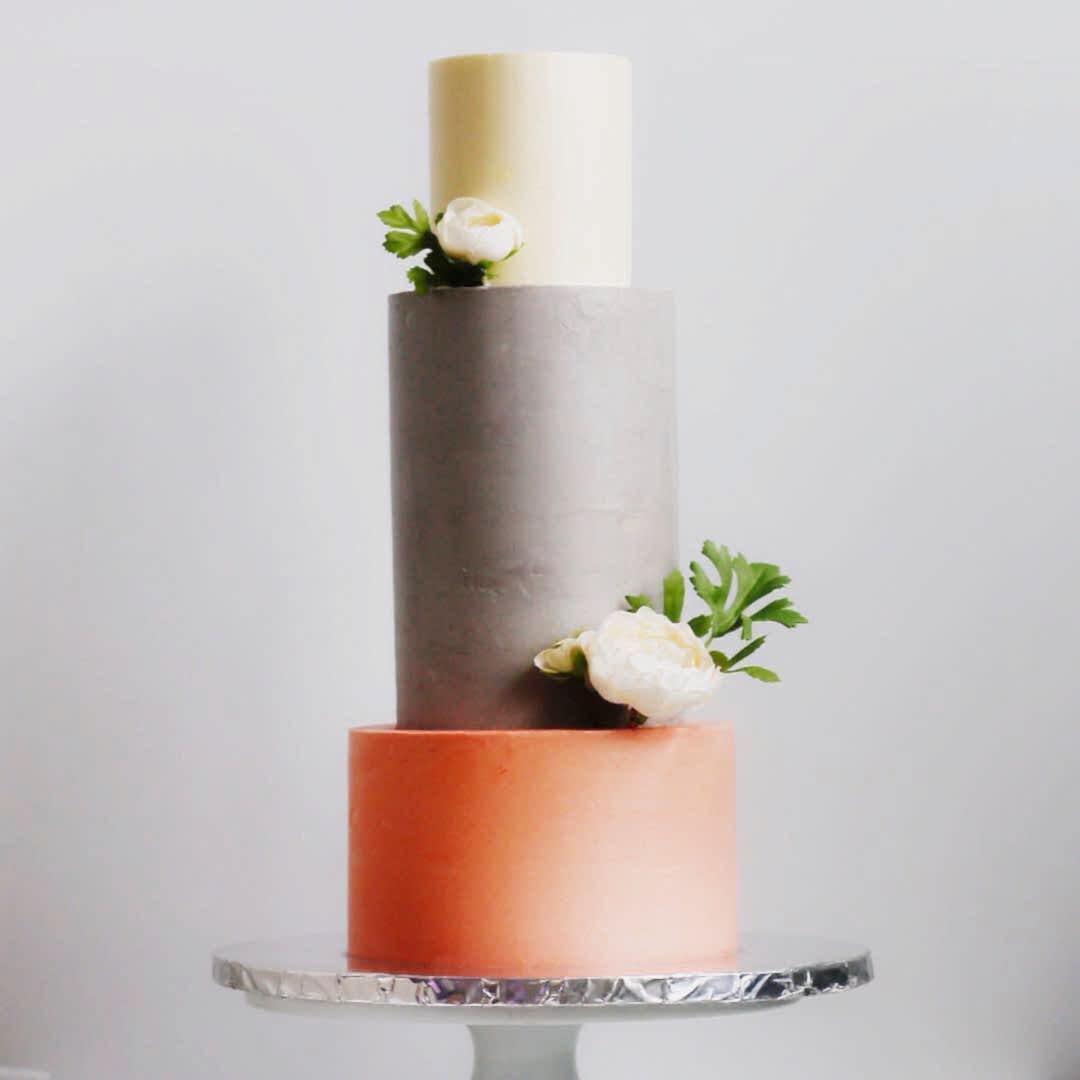 3-tiered white, grey and orange color block cake