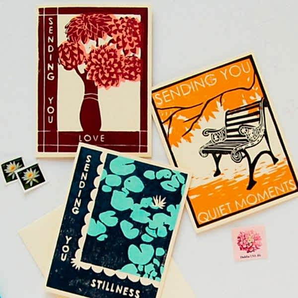 Three cards in a variety of colors on a white table for bridal shower favors