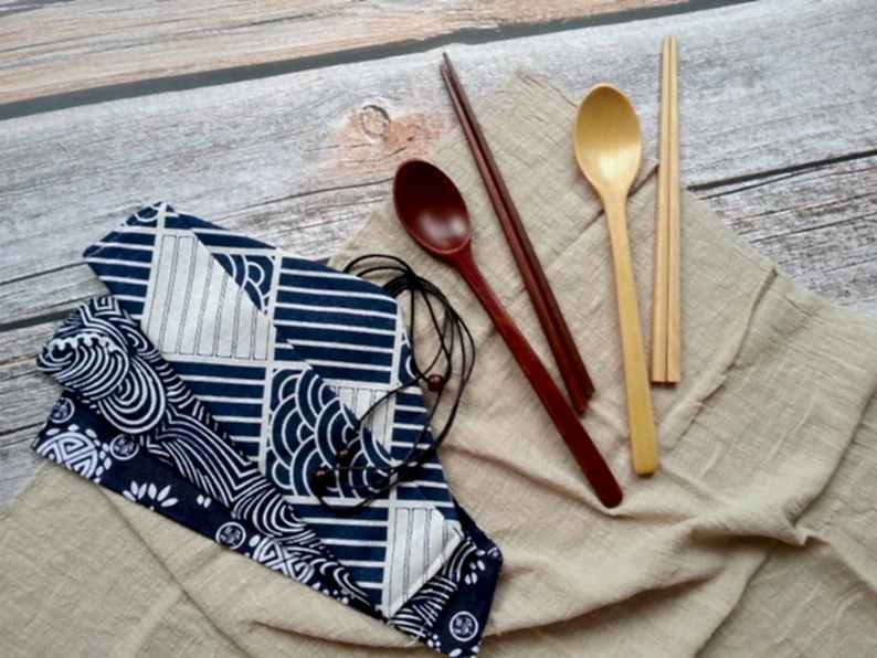 Bamboo utensils and printed carrying pouch on a napkin for bridal shower favors