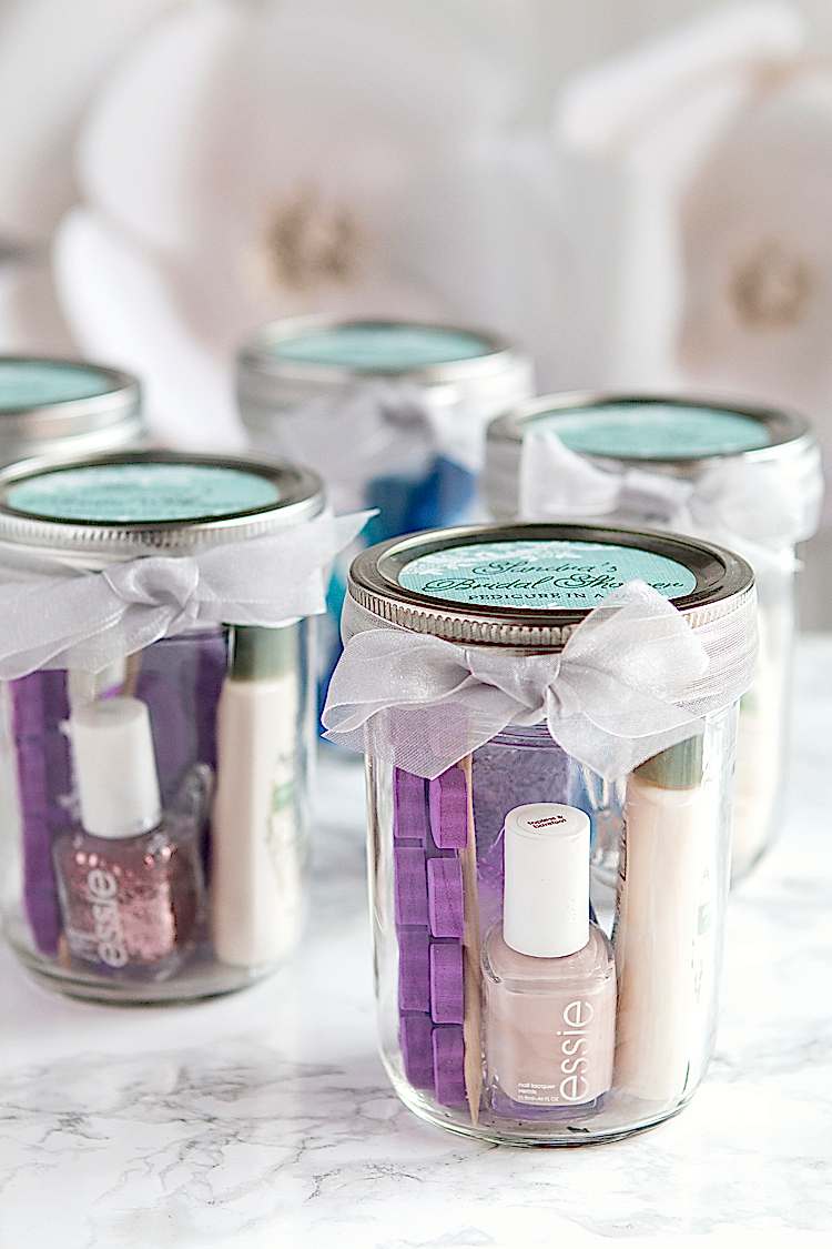 beauty products packaged in jars and tied with bows for bridal shower favors