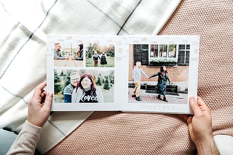 A person holds open a Mixbook photo album
