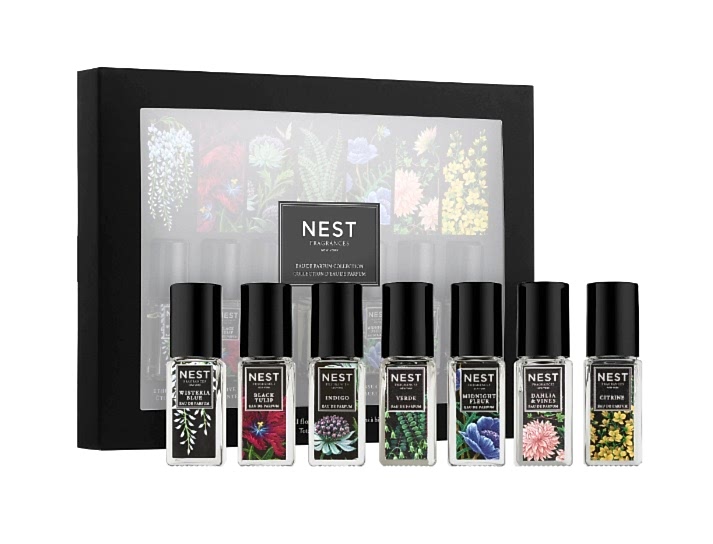 Assortment of seven NEST brand perfumes in front of box for bridal shower favors