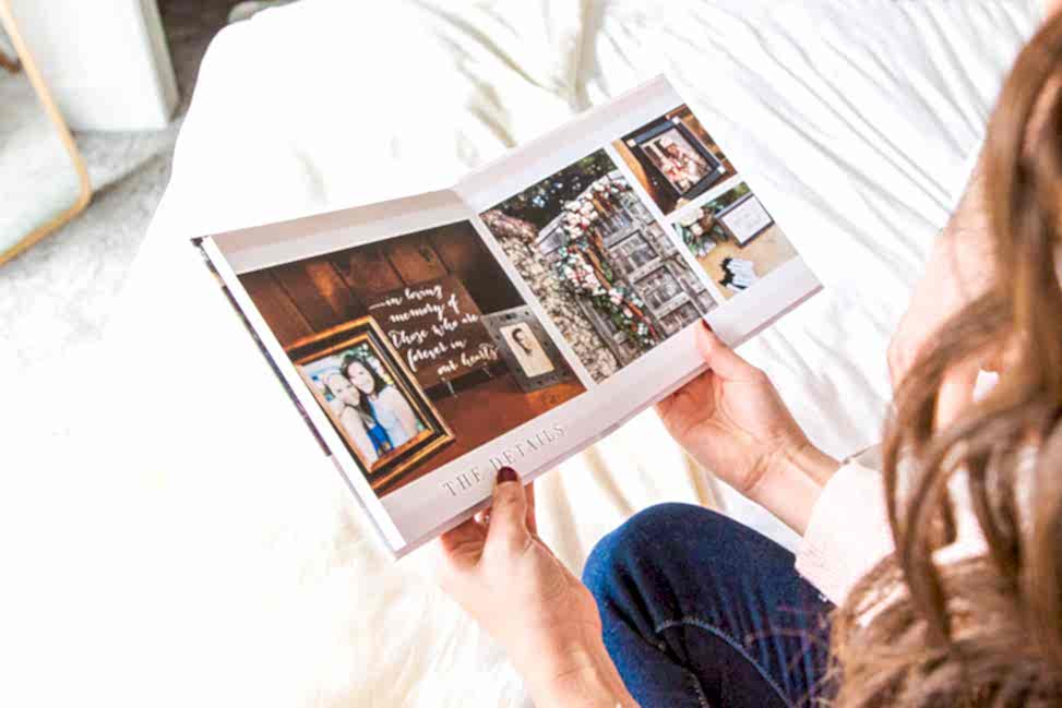 A person looks at an open Mixbook photo album