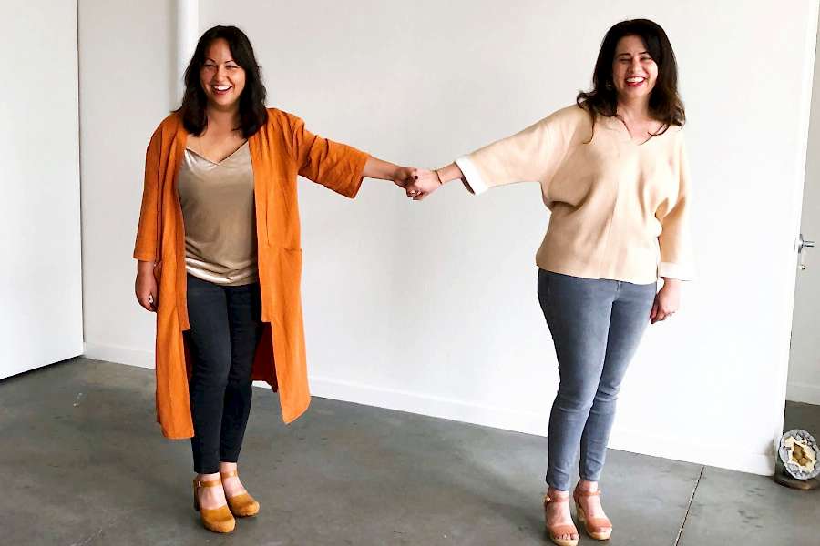 Two amazing women hold hands across a great expanse