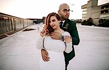 A couple embrace and look off in different directions