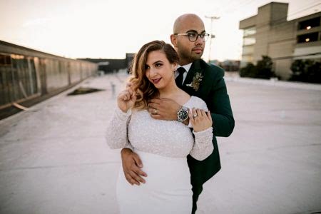 A couple embrace and look off in different directions