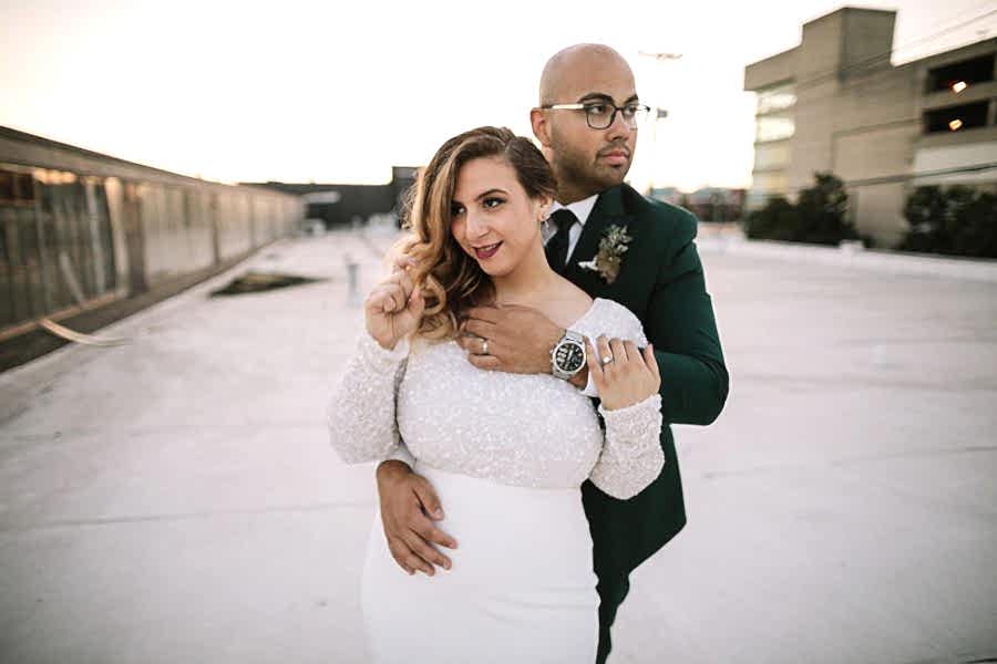 A couple embrace and look off in different directions