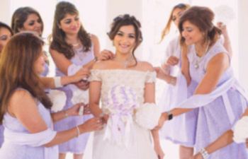 A bride is attended to by her bridesmaids