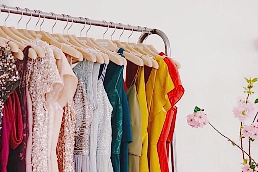 A clothing rack with various colorful dresses