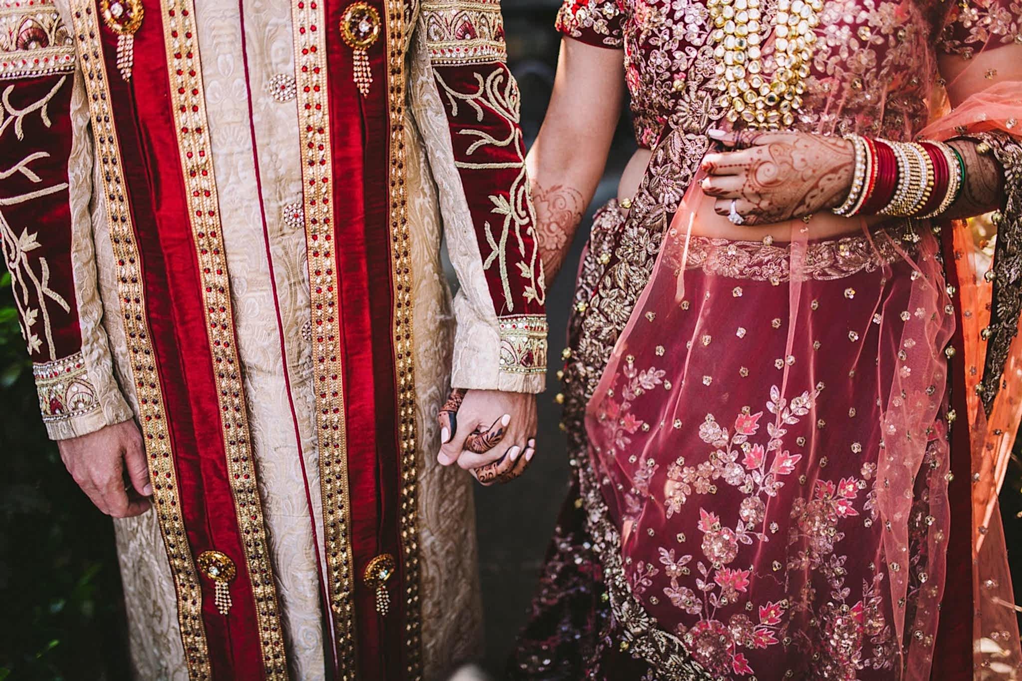 Indian wedding couple holding hands