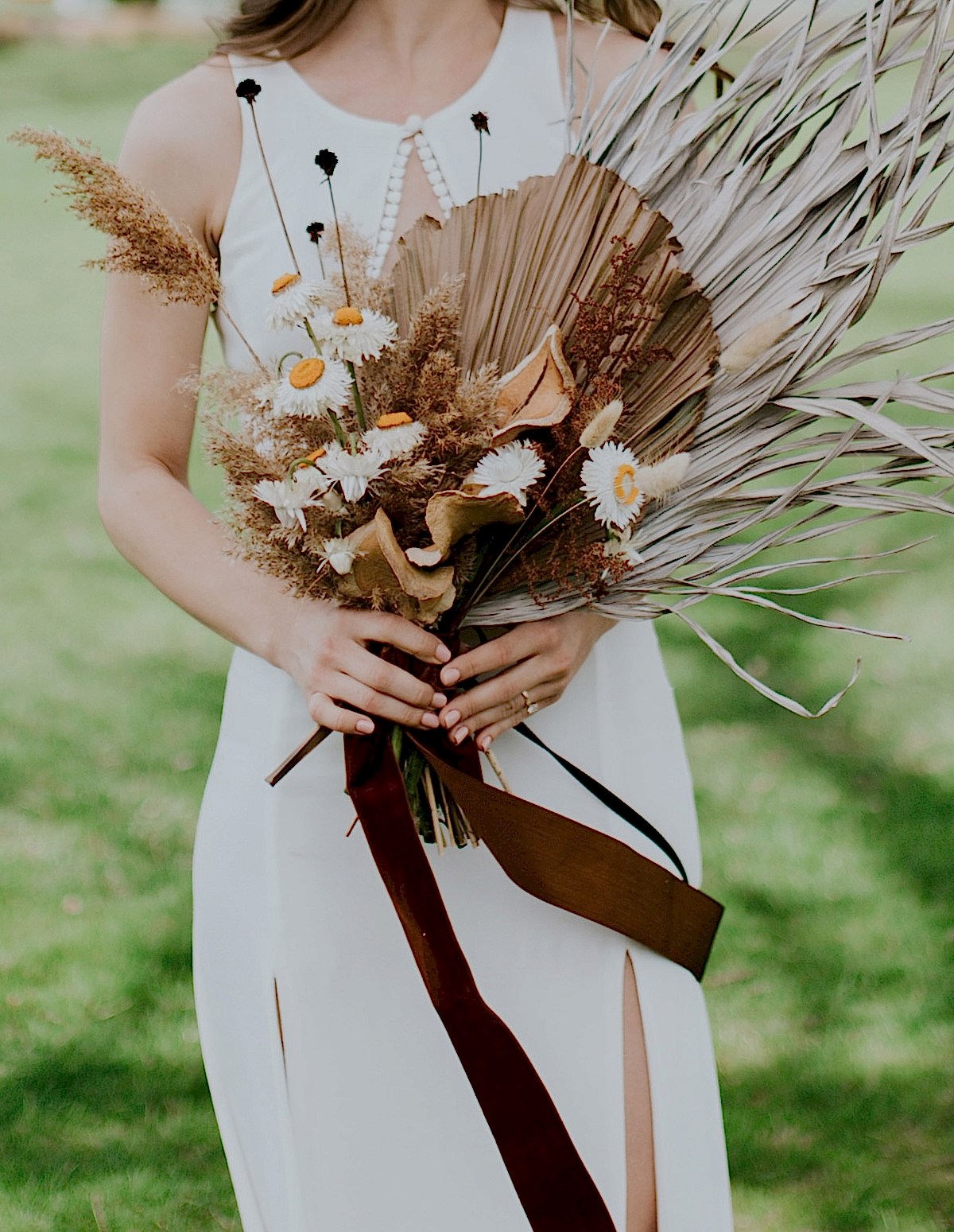 A woman holds a flower bouquet