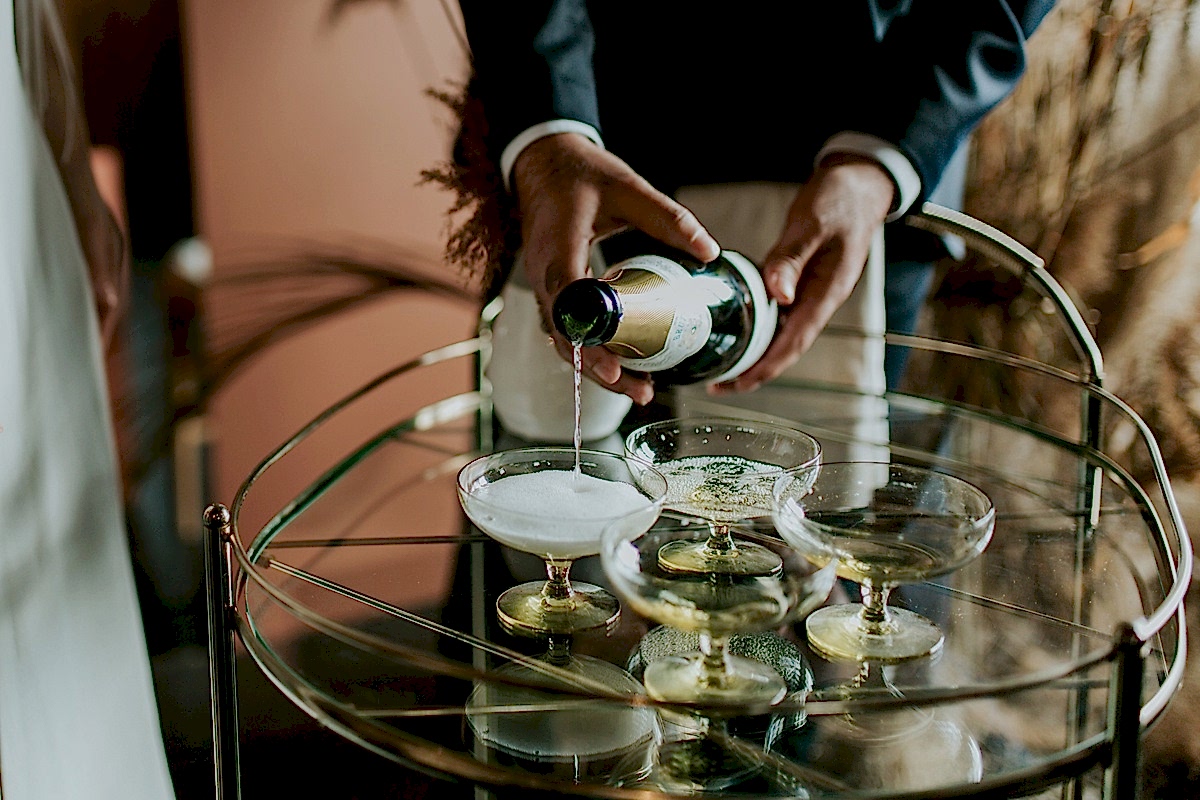 A person pours champagne into glasses