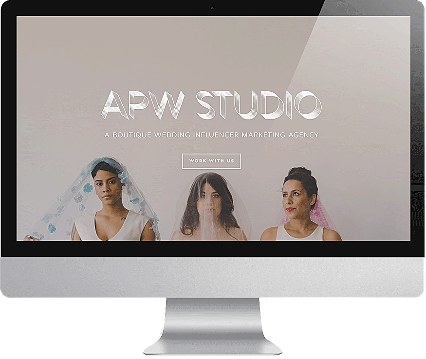 A computer screen displays the APW Studio agency website