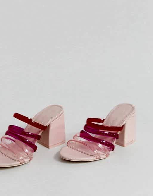 A pink sandal with red and hot pink straps