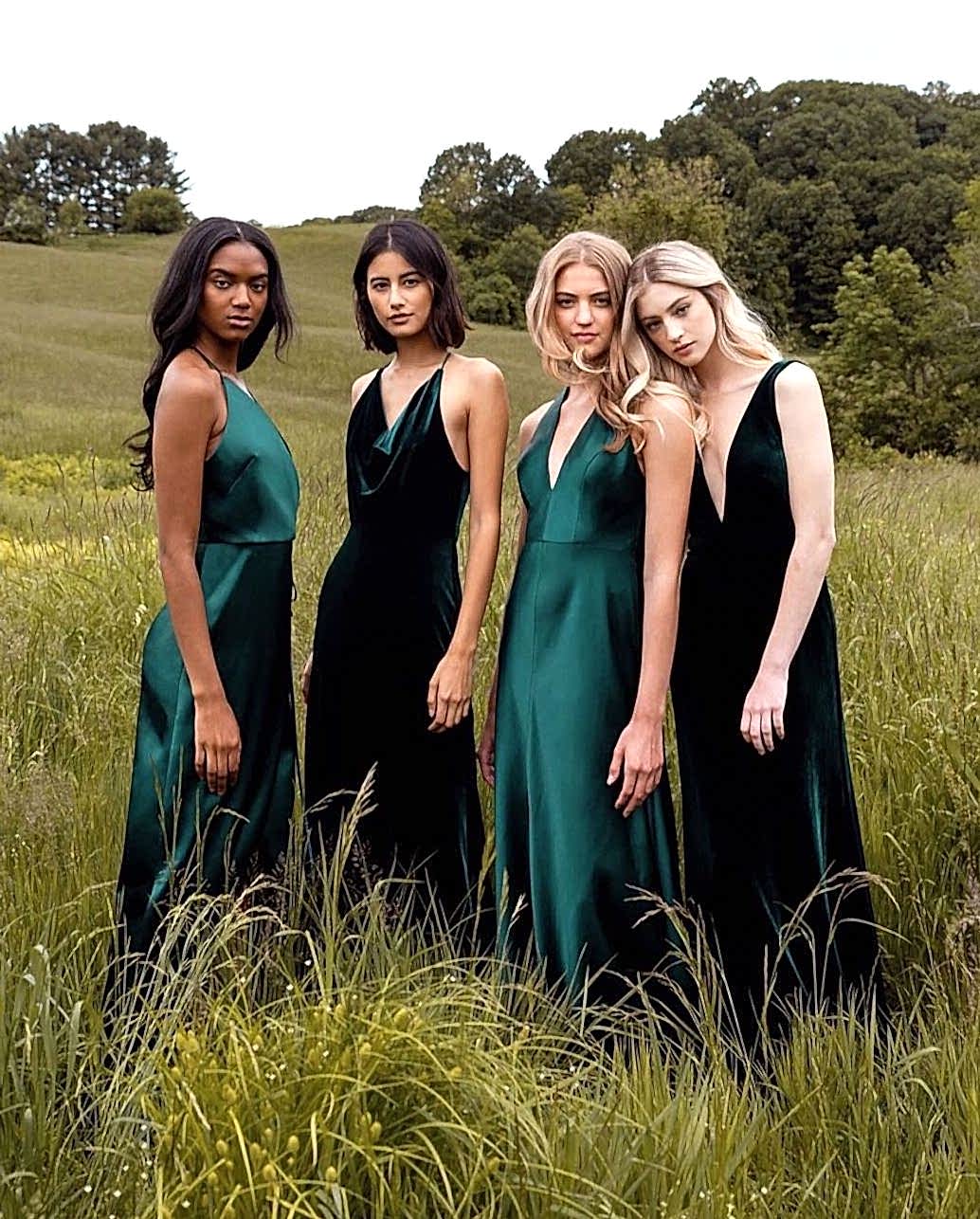 Four models wear dresses of various shades of green.