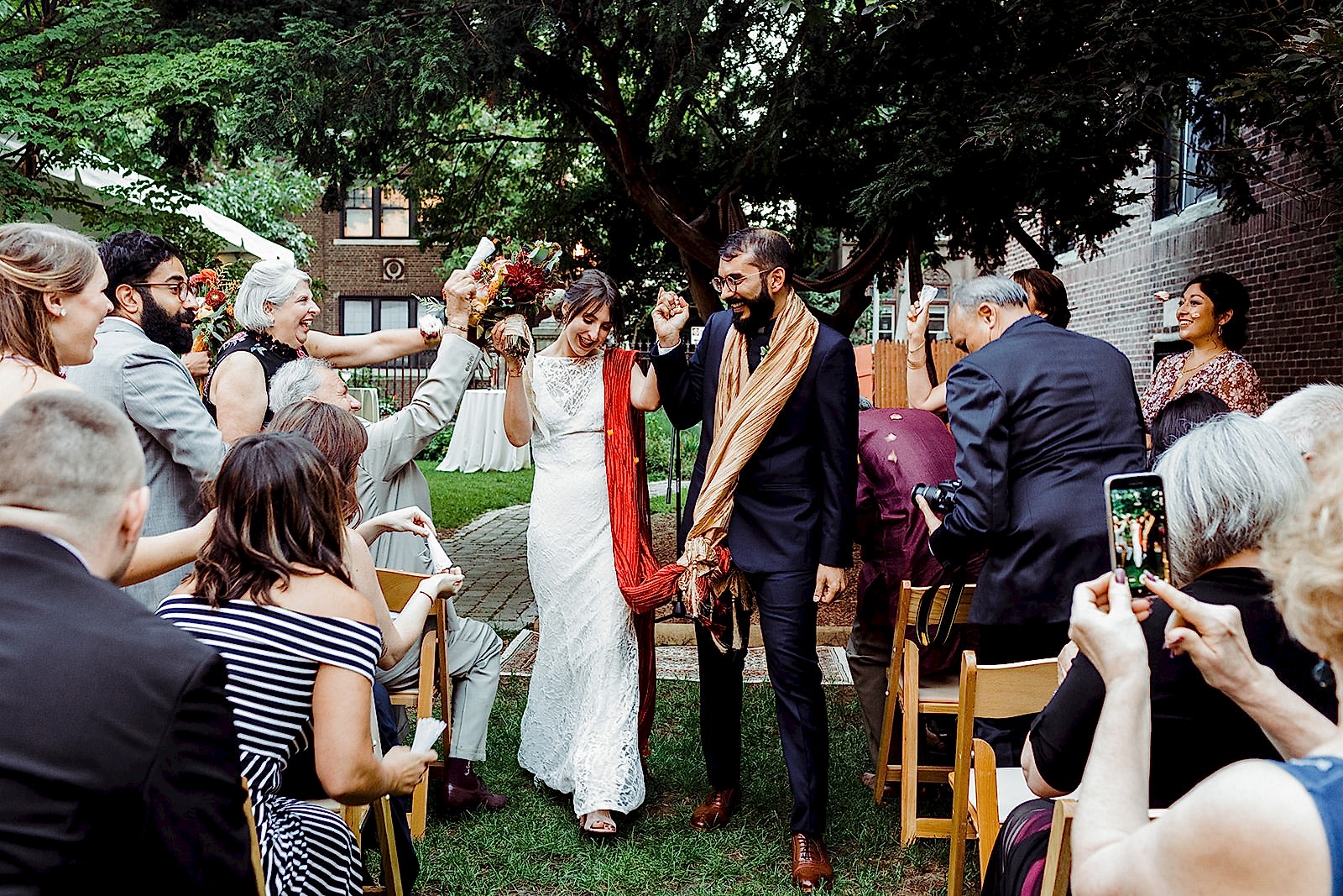 A wedding couple walk back down the aisle after their ceremony.