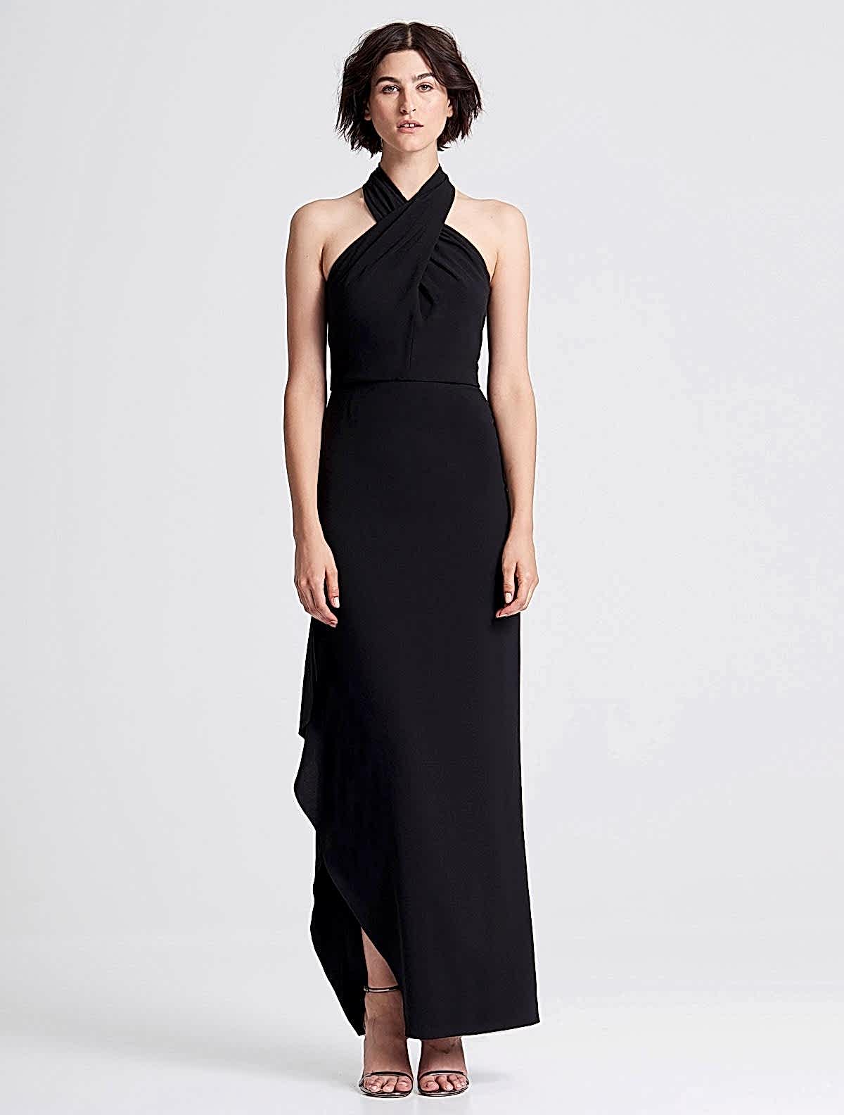A model wears a stunning cross neck black dress.