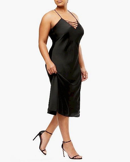 A woman wears a long satin slip style cocktail dress that's all the sultry you'll need. Black wedding dresses.