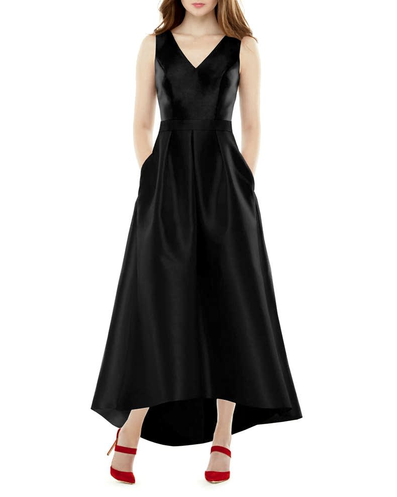 A model wears a v-neck sleeveless full length black dress.