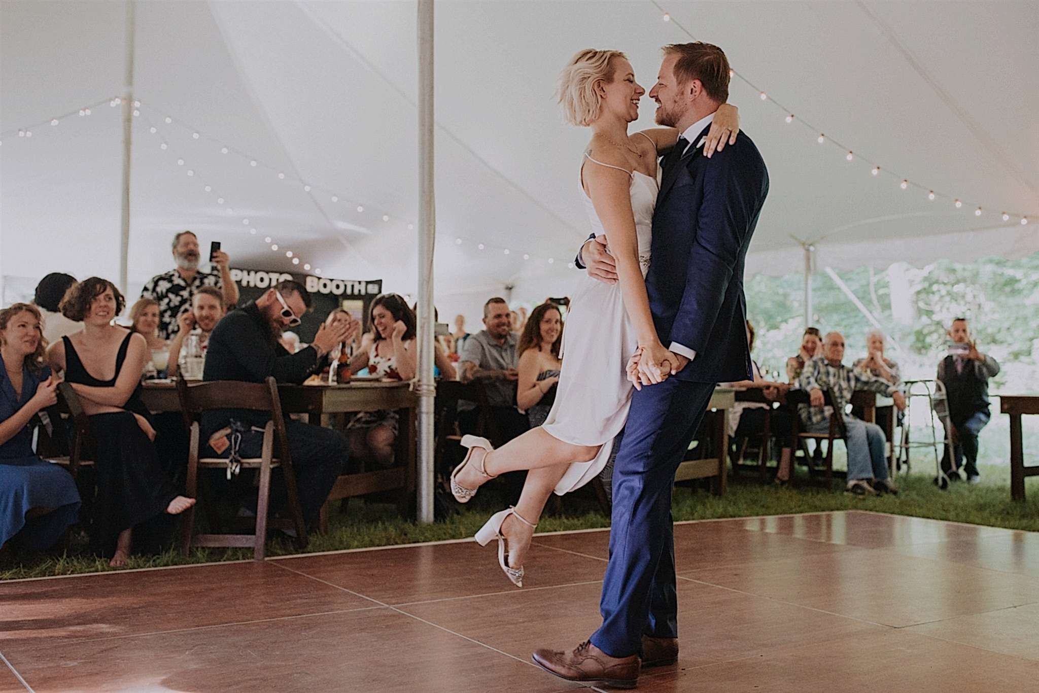 A bride is lifted up into the air during her first dance with her husband. Photo by The Commoneer.