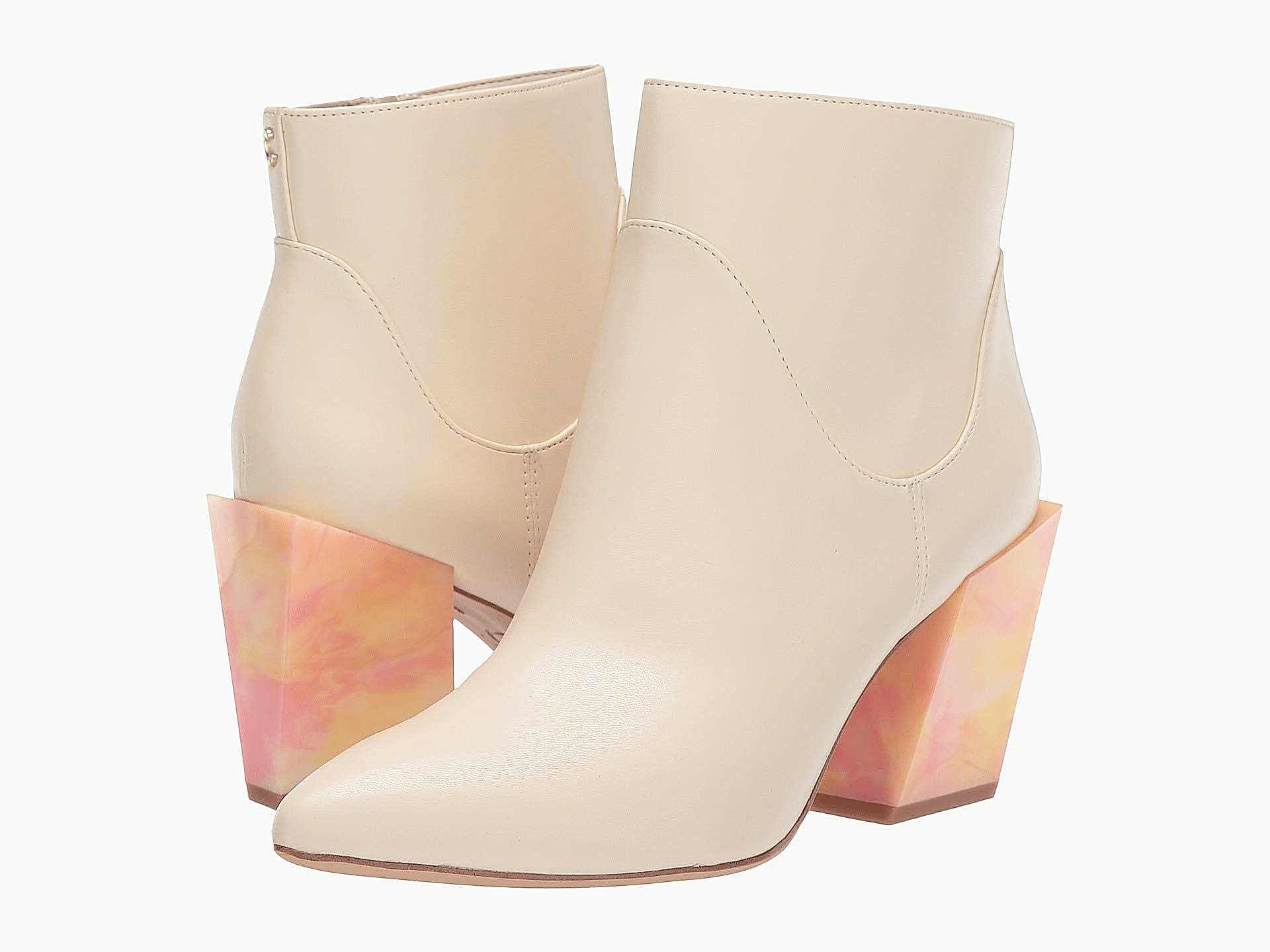 Tan colored leather boots with a marble design heel.