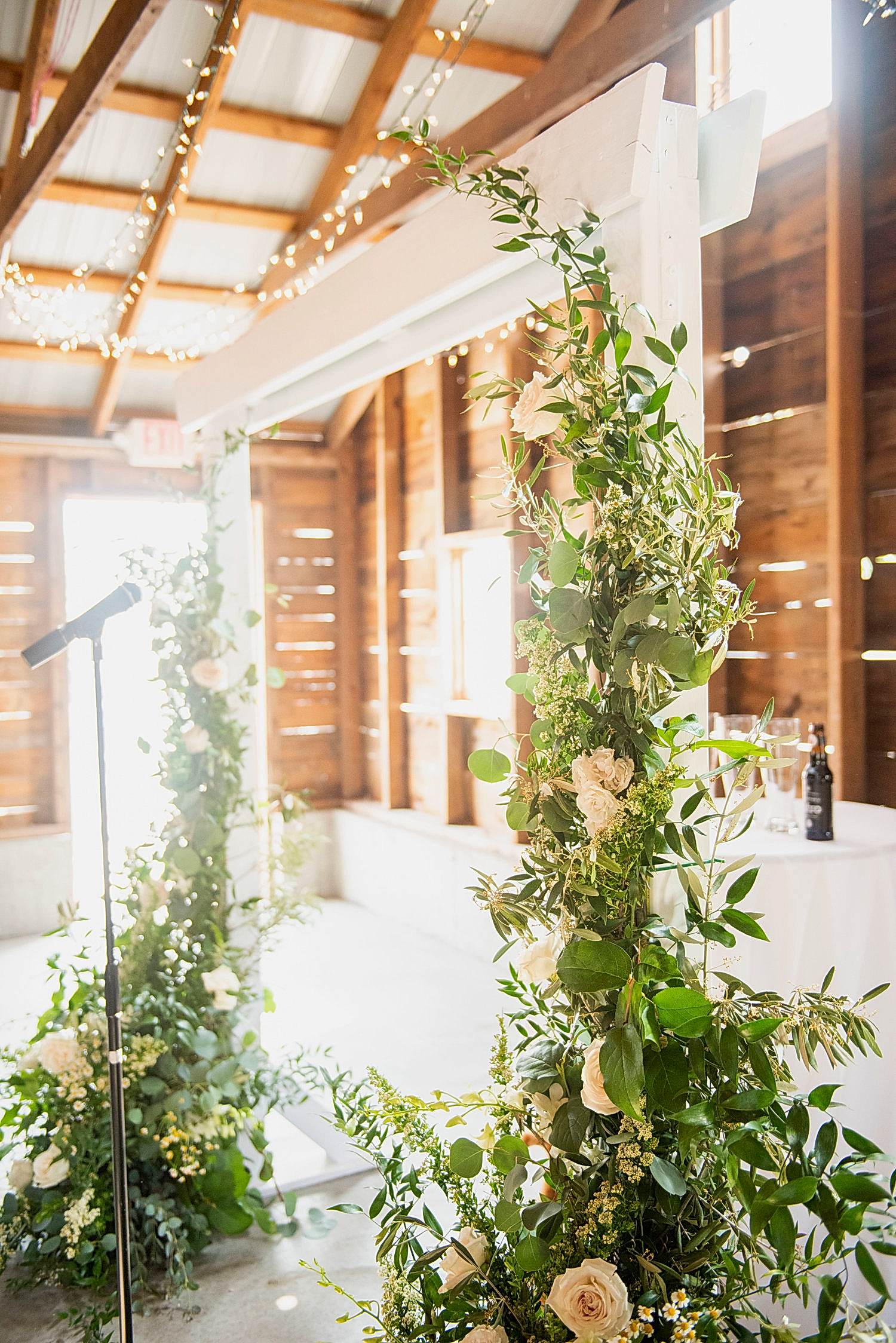 Standing floral arrangements at a wedding altar.