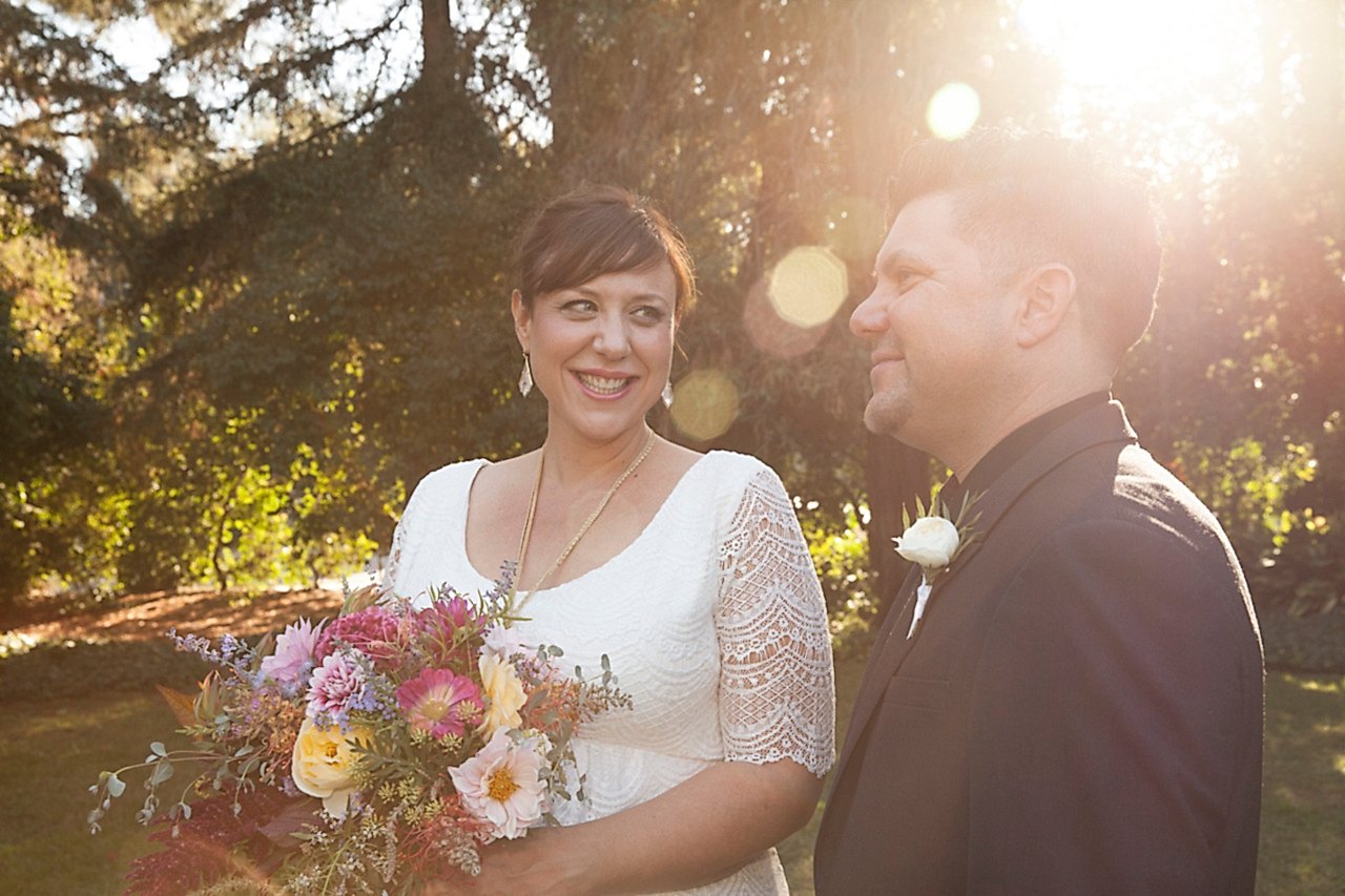 A woman smiles at a man during sunset.