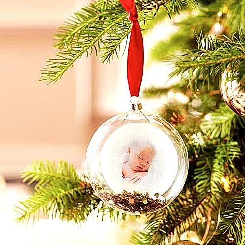 A holiday ornament with a photo inside.