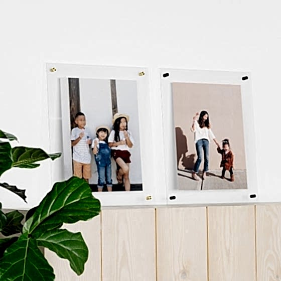 Clear floating frames with photos in them.