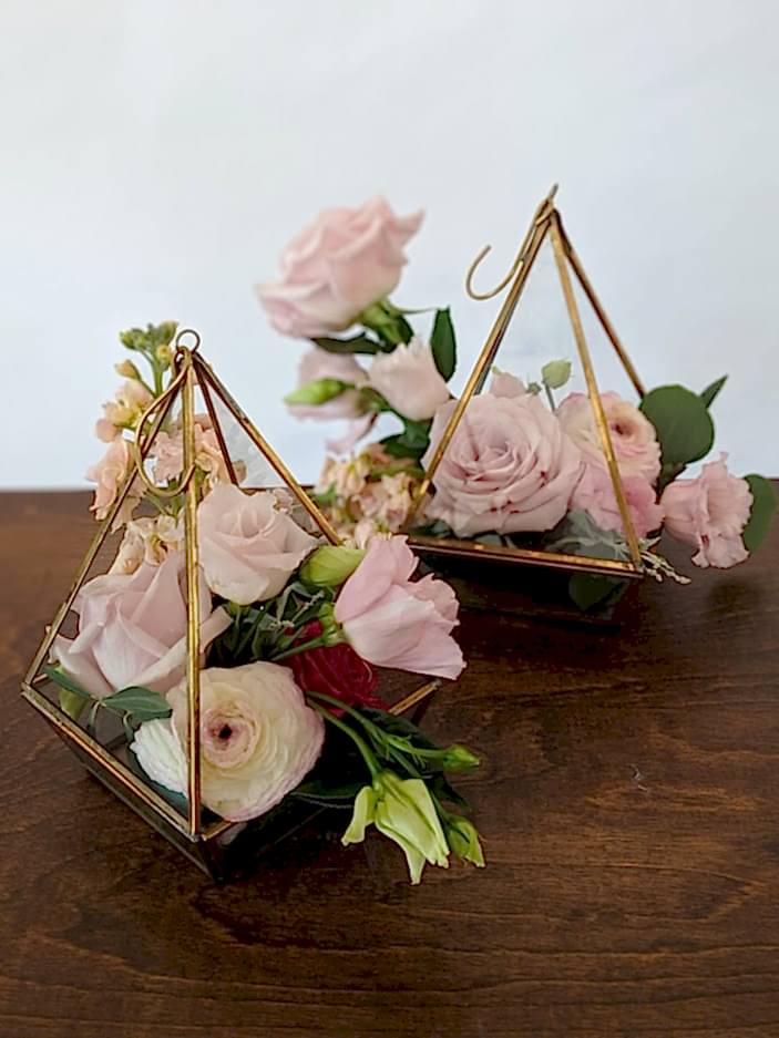 Two triangle shaped floral arrangements.