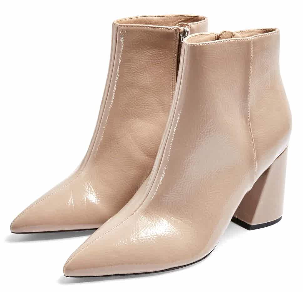 Nude color pointy boots.