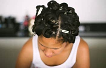 Woman getting her hair set before a wedding