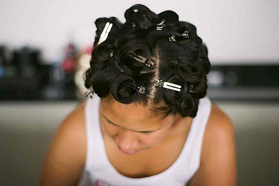 Woman getting her hair set before a wedding