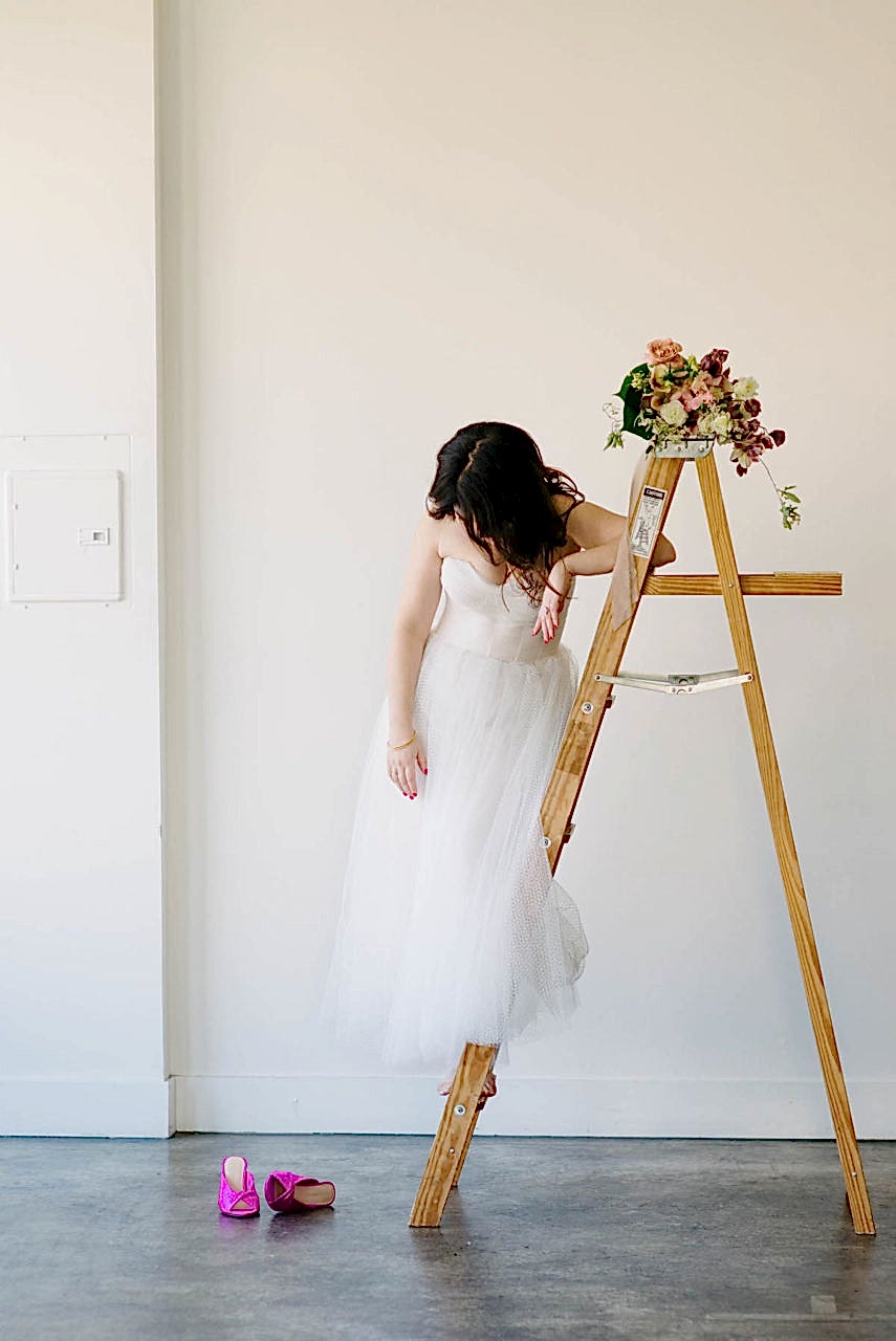 Meg still standing on a ladder.